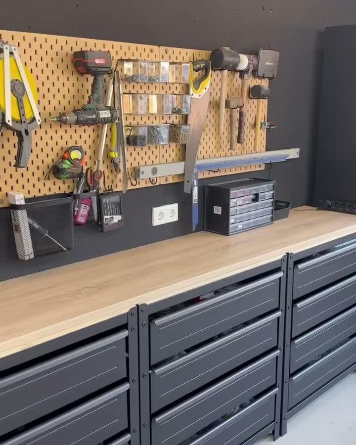 Light wood SKÅDIS pegboard and black storage cabinets in a garage workshop by @nadine_sobotzik with organized tool display.