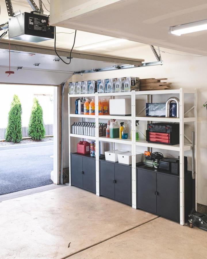 White and black metal BROR shelving system in garage by @vivandtim.home with organized storage of supplies and tools. Neat and practical setup.
