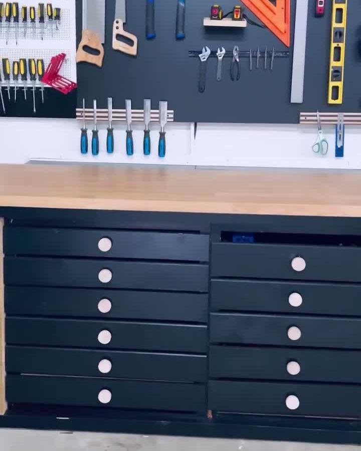 Black and natural wood garage storage setup from @build_vlog with repurposed IKEA tabletop tool wall and organized tool display.