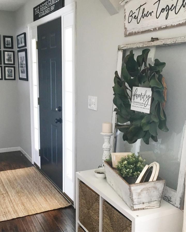 White Ikea Kallax unit with woven baskets in entryway by @bookgirlcreations featuring rustic decor and greenery ikeakallax entryway hacks.