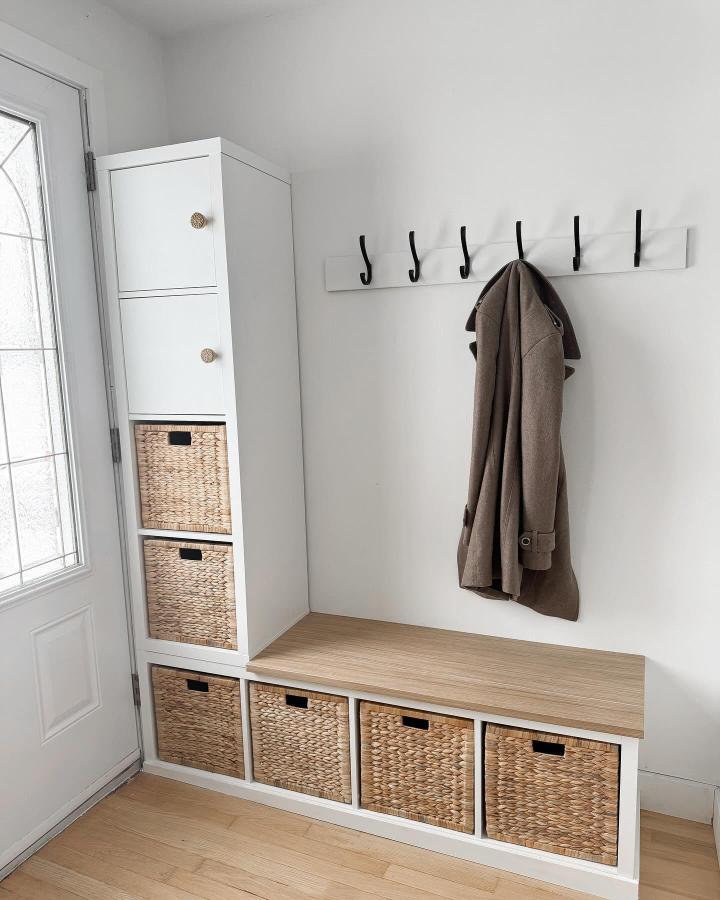 White and natural wicker Kallax-inspired entryway storage bench and tall cabinet from @jghalebxo. Stylish blending of wood and woven textures.
