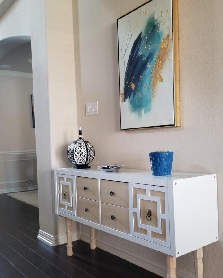White and natural wood Kallax console with geometric overlay and vintage pulls in an entryway by @kcs.living brightens and organizes the space elegantly