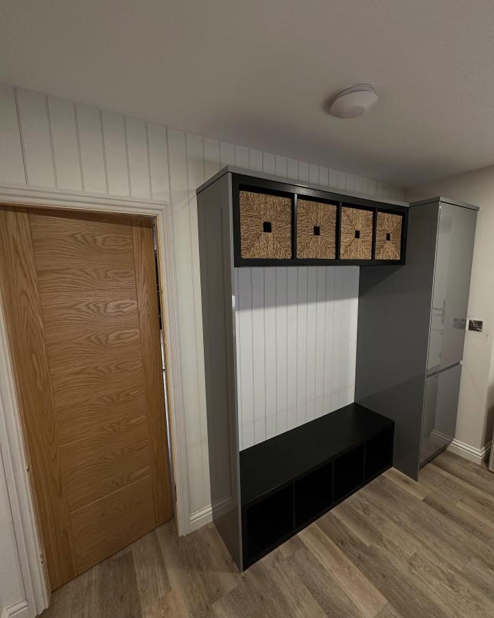 Black painted Ikea Kallax entryway unit from @ashworthjoinery featuring woven baskets and cubby seating perfect for ikea kallax entryway hacks.