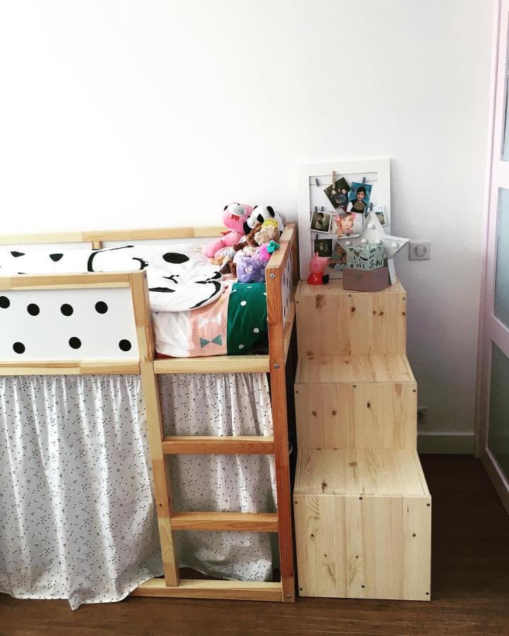 Natural pine TROFAST staircase with fabric curtain and playful bedding on Ikea Kura loft bed from @catcatvictoiresoline. Ikea kura and trofast bed hacks creating cozy kid’s space.