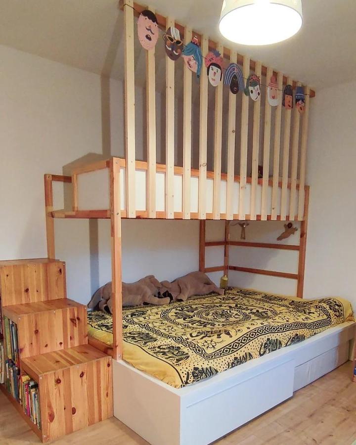 Natural wood KURA bed with TROFAST staircase and under-bed storage from @gruen.kind featuring ikea kura and trofast bed hacks for functional kids room organization