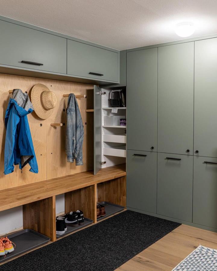 Sage green painted cabinets and natural wood bench mudroom lockers from @braveelement showing smart ikea mudroom lockers hacks with pegboard and storage.