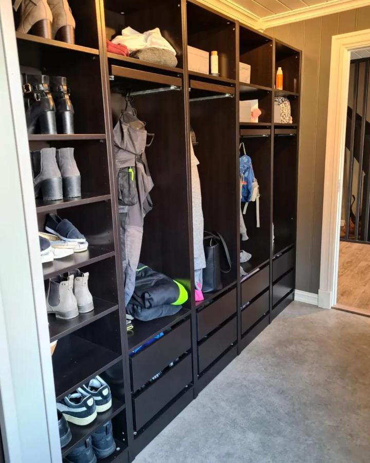 Black custom mudroom lockers made from Ikea Pax wardrobes by @uvdalsvegen with shoes, jackets, and drawers for organized entryway storage