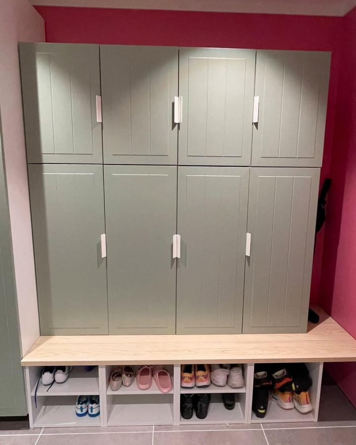 Green sage paneled lockers with white handles and wood bench in mudroom from @dortesunivers. Ikea mudroom lockers hacks with shoe cubbies below the bench.