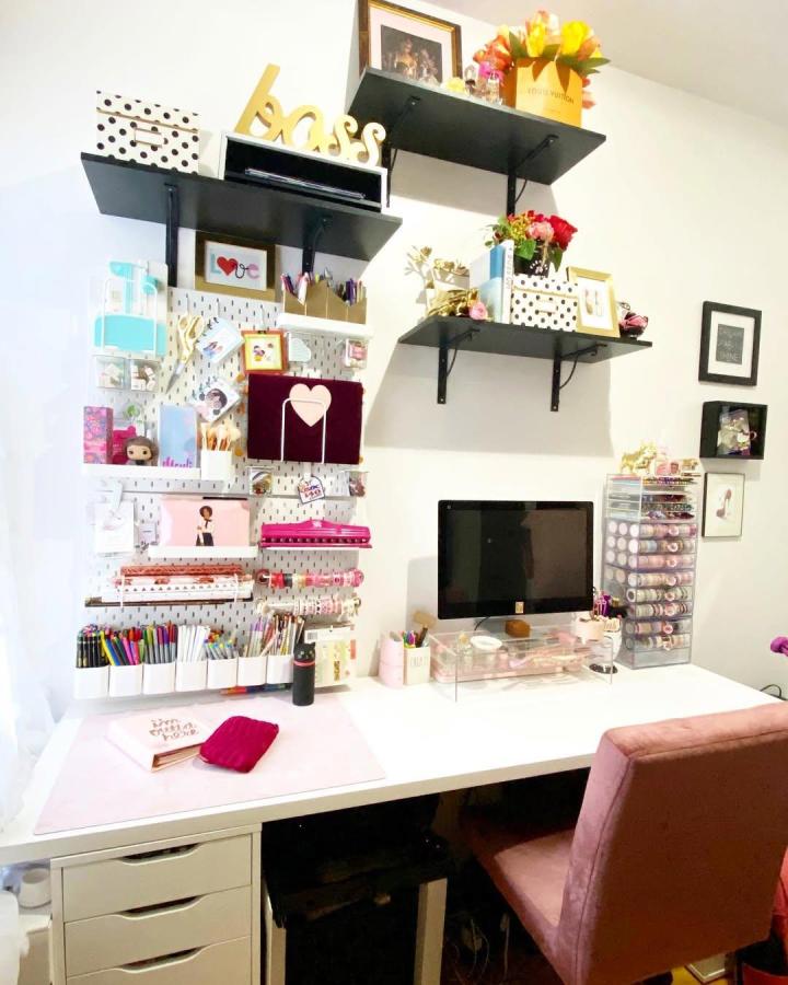 White polka dot pegboard and black shelves office setup from @missmerli showing creative ikea office pegboard ideas for stylish organization