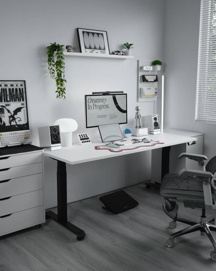 White minimalist pegboard workspace from @mark.setup with hooks, trays, and greenery for organized modern office setup.