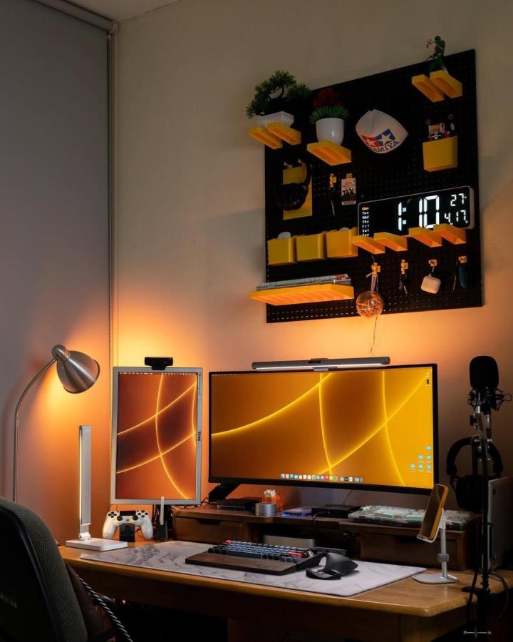 Yellow and black pegboard with shelves and hooks in home office setup by @bimo_nuksmo bright and functional organization solution.