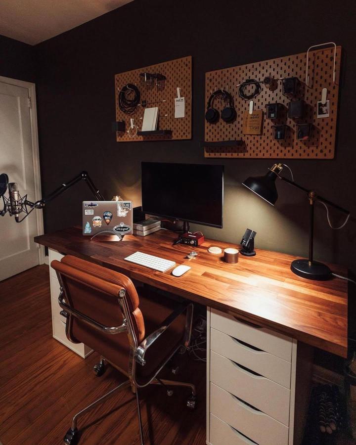 Brown wood pegboards in a home office from @bonannodiaries with organized tech accessories and warm decor. Simple and functional storage.