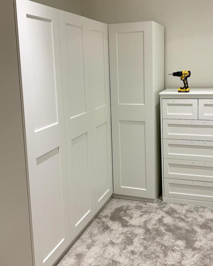 White shaker style Ikea Pax corner wardrobe ideas from @jodieandhome. Crisp doors, clever corner unit, and matching drawers creating seamless storage.