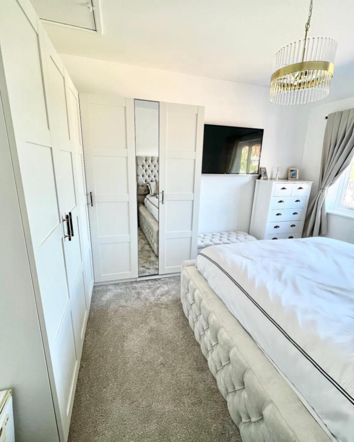 White paneled Ikea Pax corner wardrobe with mirror doors in a bright bedroom by @livingatrosendale showing functional and stylish ikea pax corner wardrobe ideas.