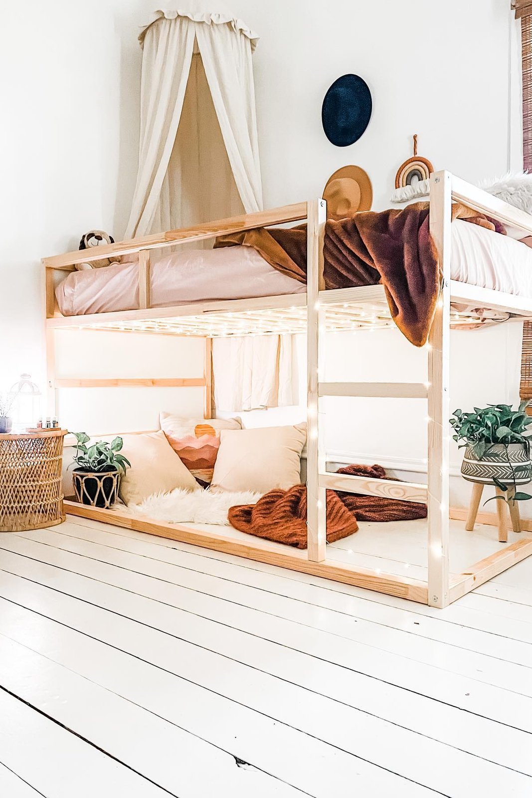 KURA bunk bed with canopy, fairy lights, layered bedding, and cozy under-bed nook accessories