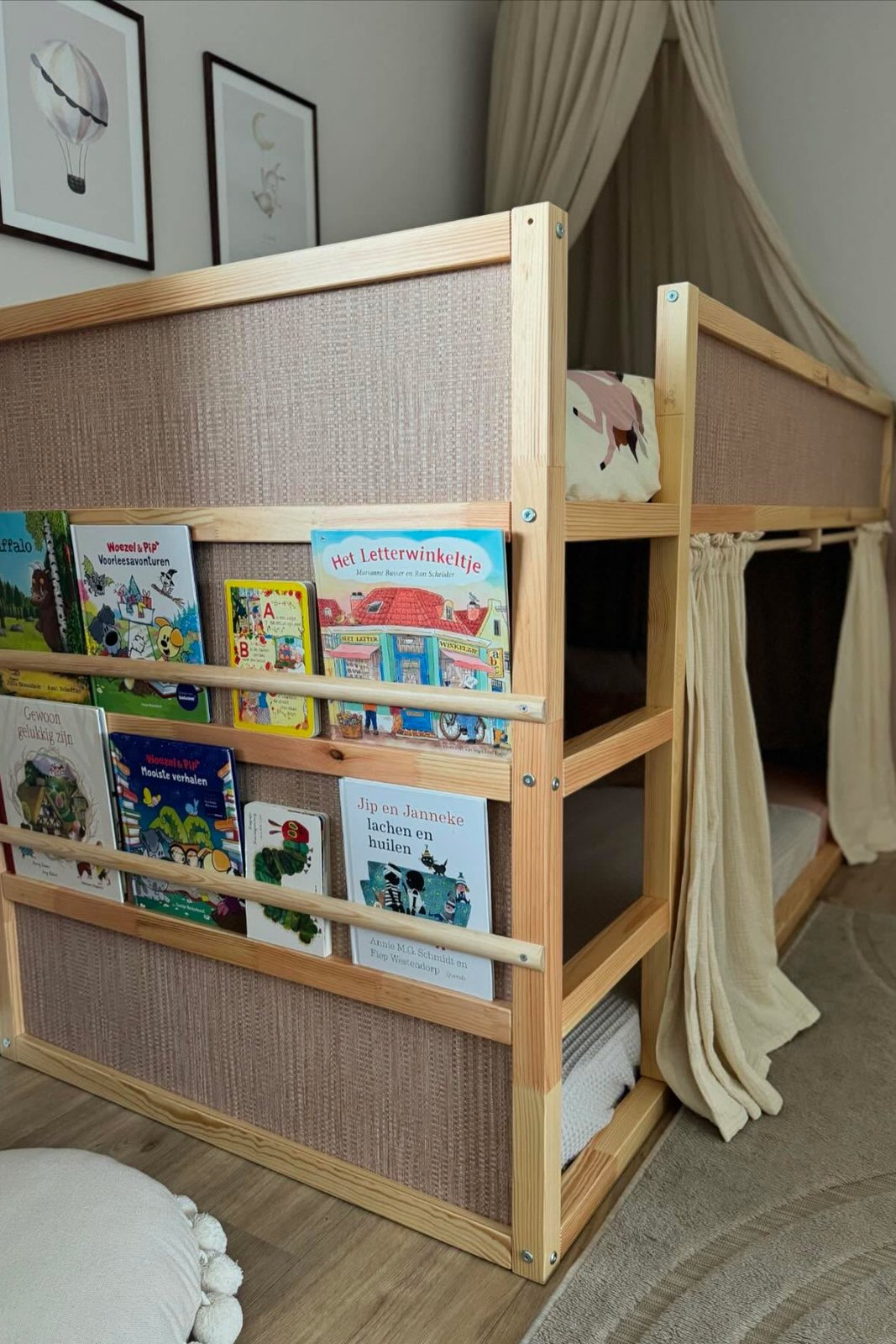 Natural wood KURA bed with woven panels, front book display, and under-bed curtains