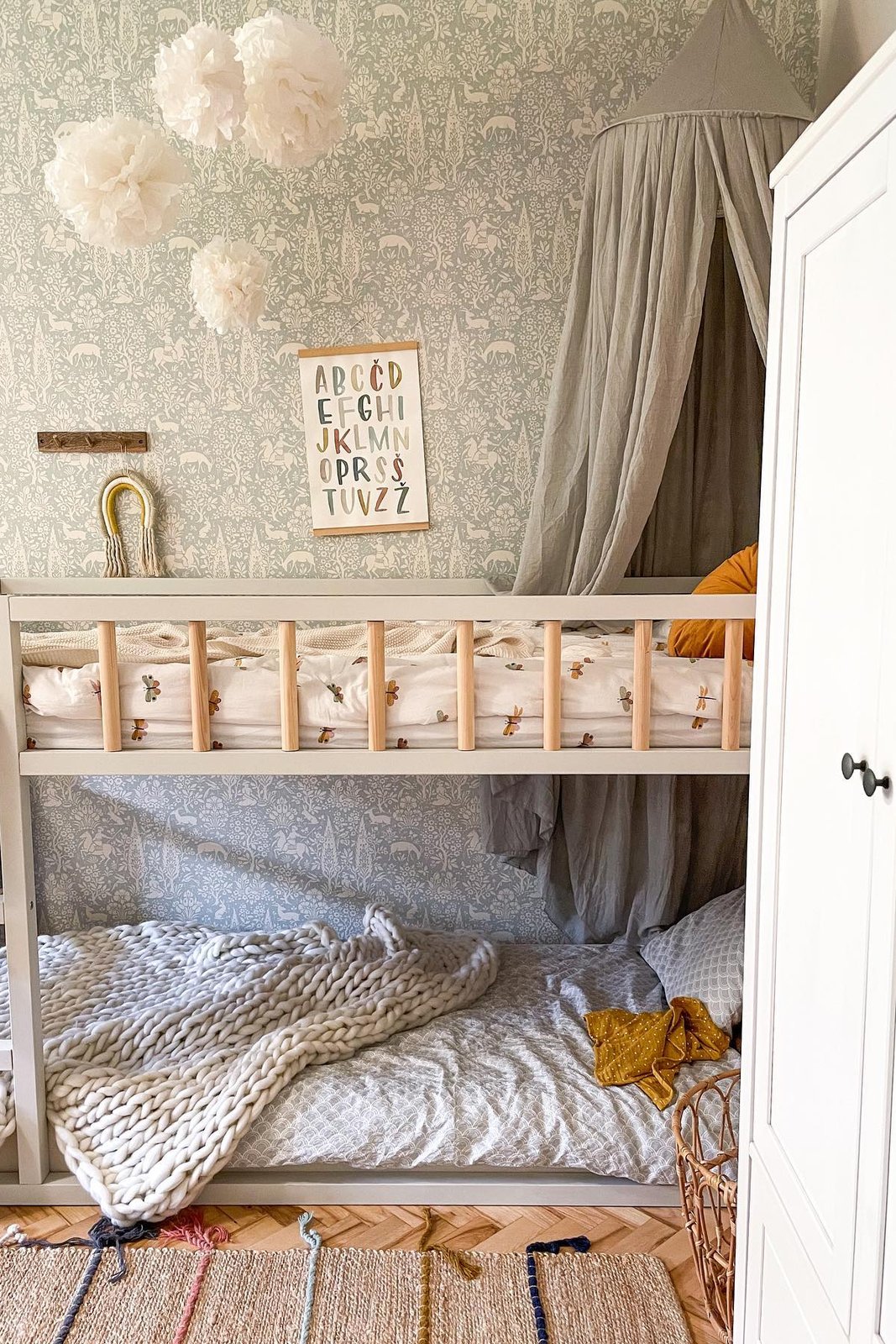 Grey canopy, knitted blanket, and floral bedding among the best accessories for ikea kura beds