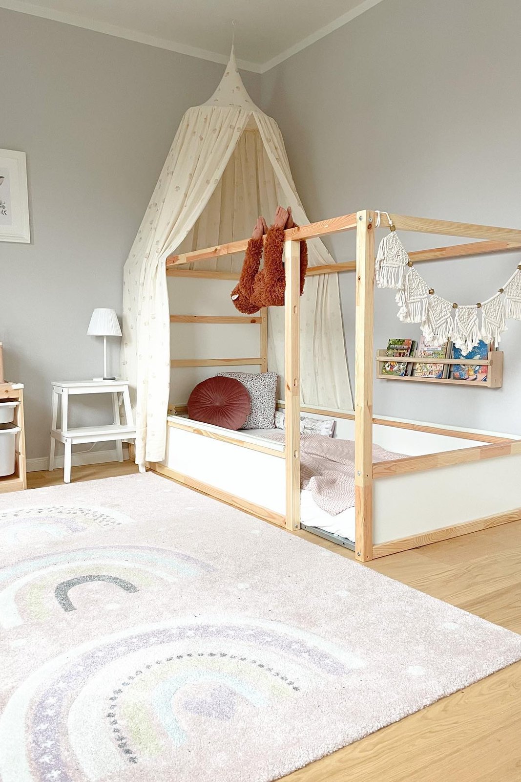 Best accessories for ikea kura beds featuring a canopy, wall book sling, bunting, and cozy bedding
