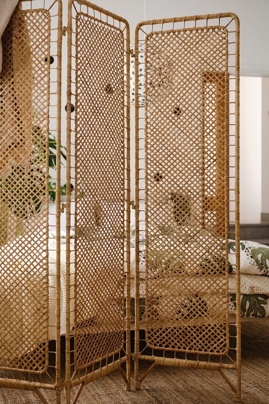 IKEA room divider selection with woven rattan panels in a cozy bedroom