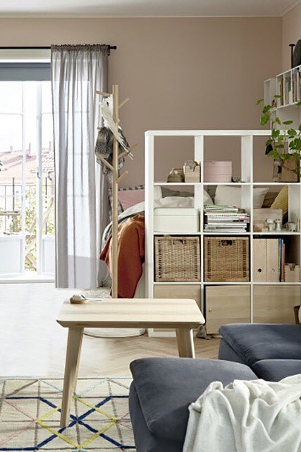 KALLAX shelving room divider idea for separating a studio bedroom and living area with storage