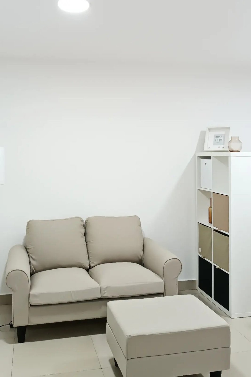 White KALLAX shelving helps divide a compact living room while adding stylish storage