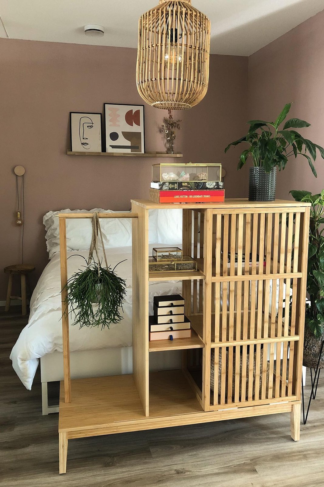 IKEA NORDKISA slatted cabinet divider separating a bedroom with warm wood storage and airy privacy