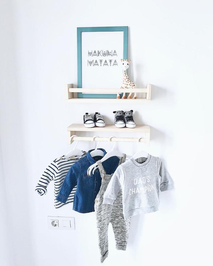 Natural wood Ikea Bekvam nursery ideas shelf with baby clothes, soft toys, and shoes from @mydecocorner stylishly organized.