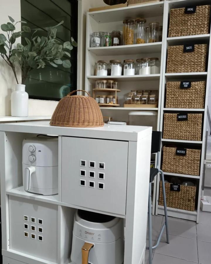 White modular kitchen storage from @murnihome with BILLY bookcase and KALLAX baskets organized pantry essentials and appliances neatly.