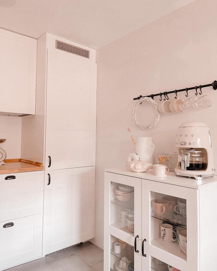 Creamy white IKEA BRIMNES cabinet coffee nook from @urkitoshome with glass doors and hanging mug rail creating a cozy brewing corner.