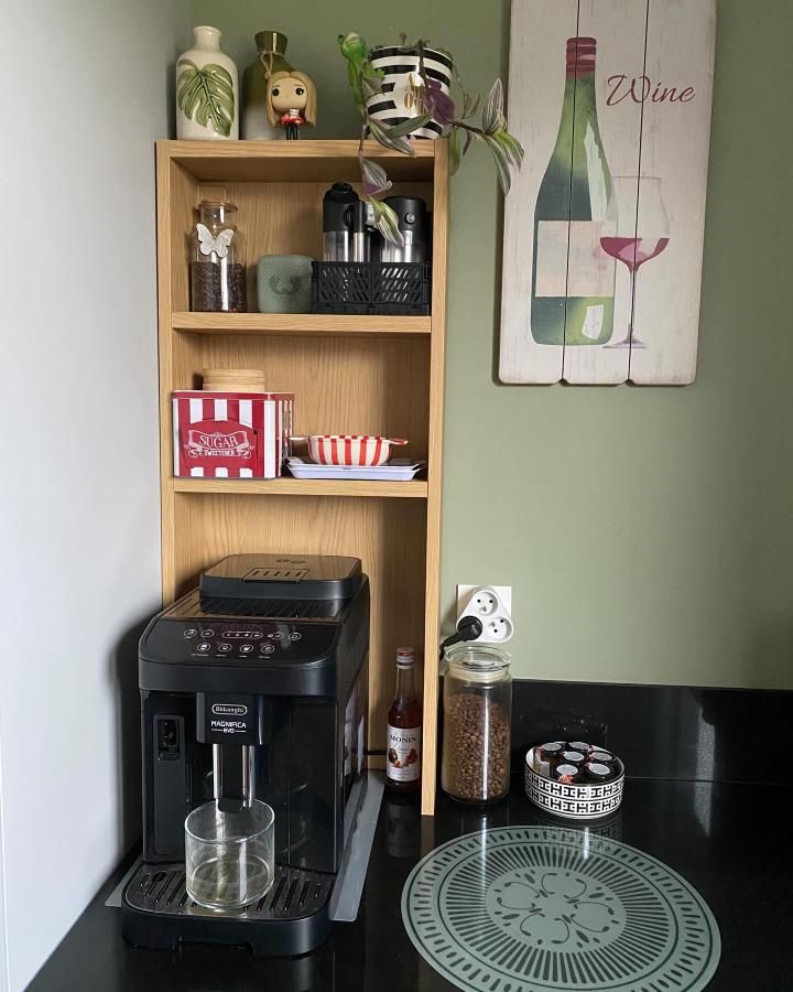 Light wood HAGAÅN shelf and black coffee machine with glass jar and decorative accents by @laulocass in cozy kitchen corner.