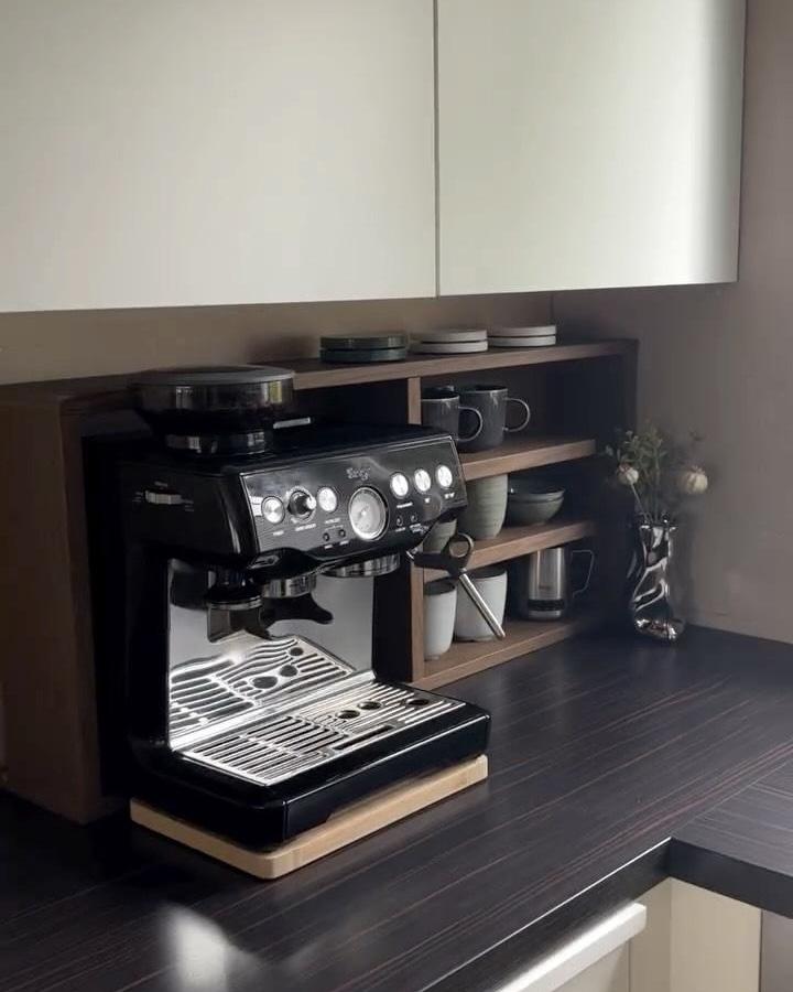 Dark wood Ikea HAGAÅN shelving coffee nook from @in.tete.rior with mugs and coffee machine on countertop.