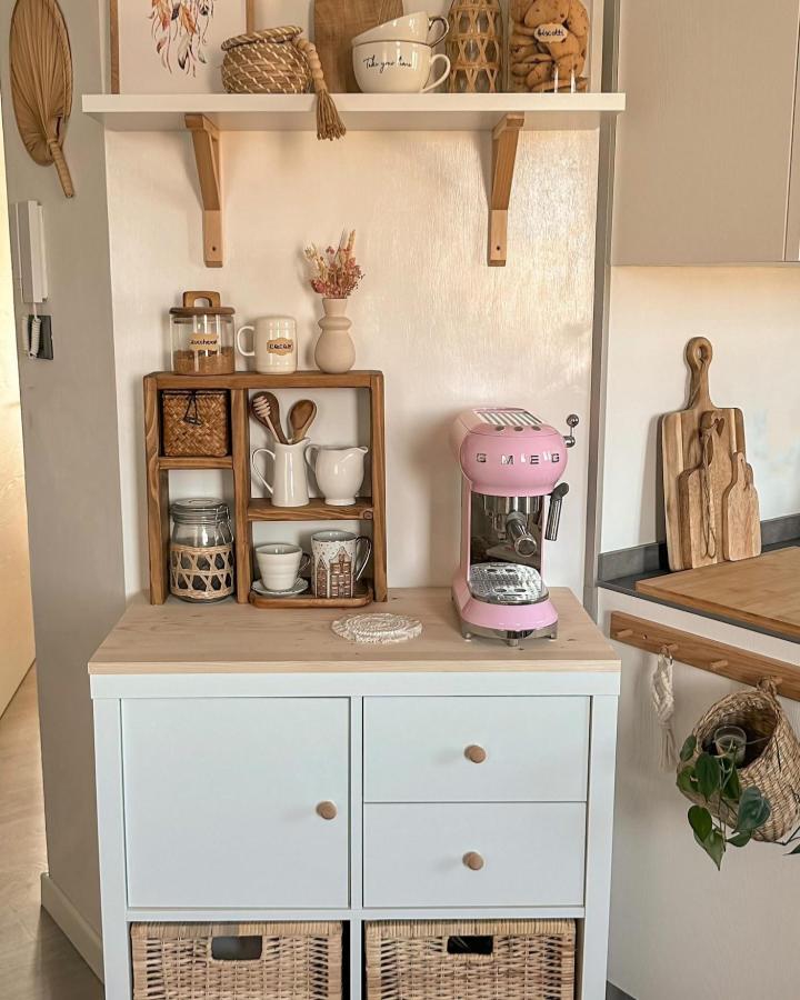 Pink espresso machine coffee nook with wood shelves and wicker baskets from @deborah_sweethome with cozy natural accents and minimalist style