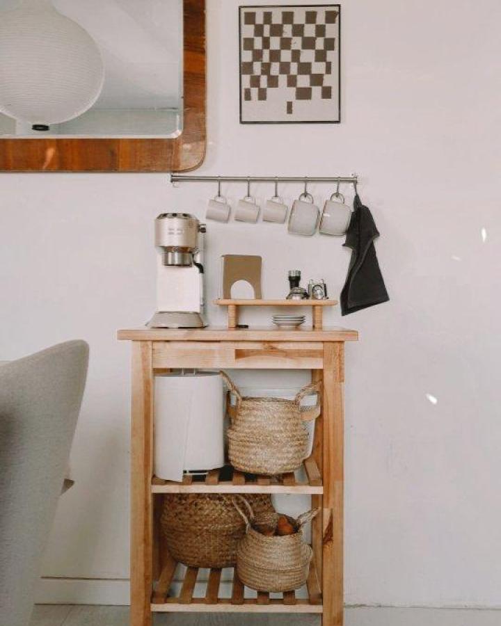 Light natural wood IKEA BEKVAM coffee station with woven baskets from @homebymonn. Cozy ikea coffee station ideas with mug rack and minimalist style.
