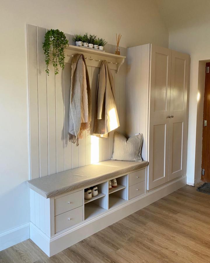 Cream cushioned bench with Ikea KALLAX storage and vertical paneling by @skyebarnconversion showing stylish ikea drop zone ideas for organized entryways.