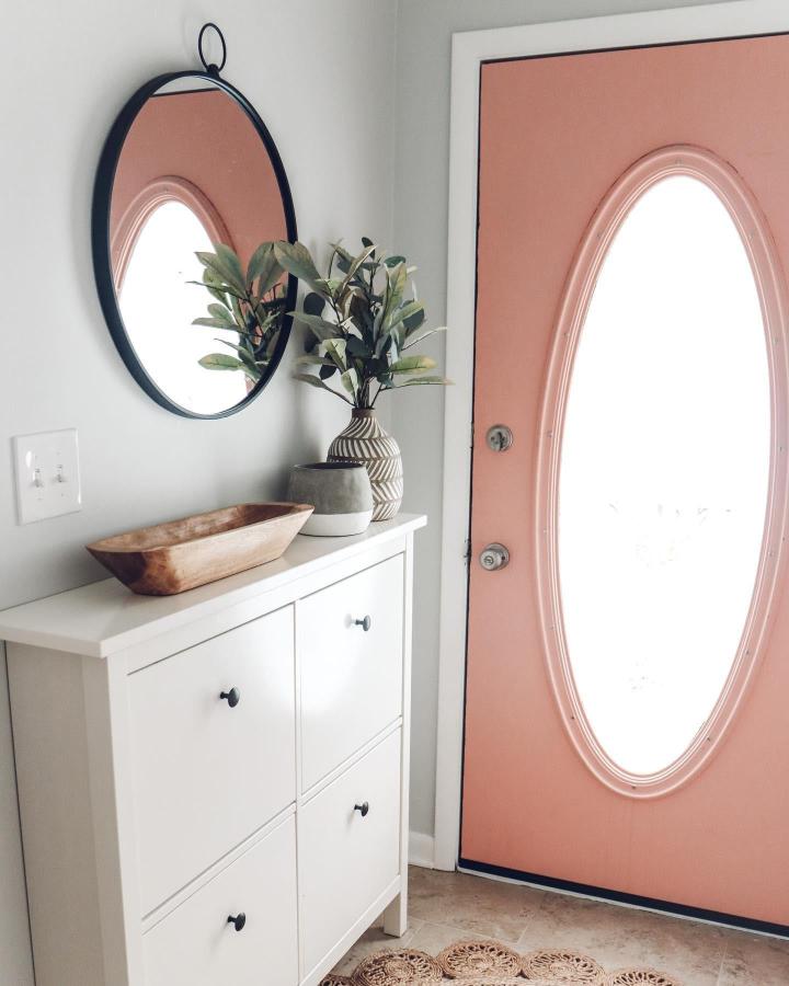 White Hemnes shoe cabinet with rustic decor and round mirror entryway from @bhgrestarhomes soft peach door background light-filled setup.