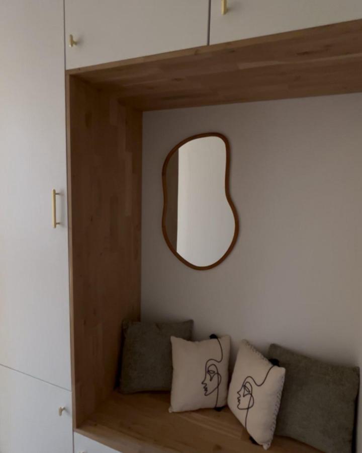 Natural wood and white Ikea PLATSA drop zone from @homeofsaliha with curved mirror and artistic pillows for ikea drop zone ideas.
