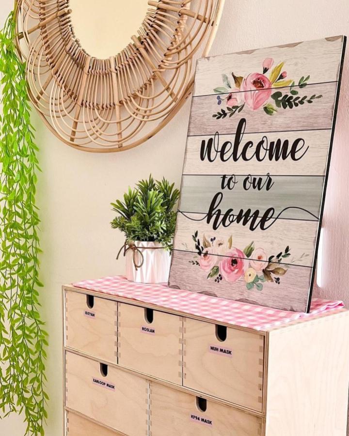Natural wood MOPPE drawer unit with personalized labels and pink fabric top from @idzyanismail in a cozy home entry decor setup.