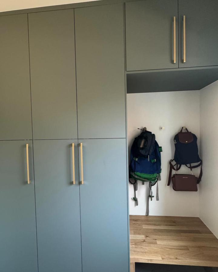 Matte blue IKEA PLATSA storage with hooks and wooden bench from @swedeandsimple_ in a tidy organized entryway drop spot.