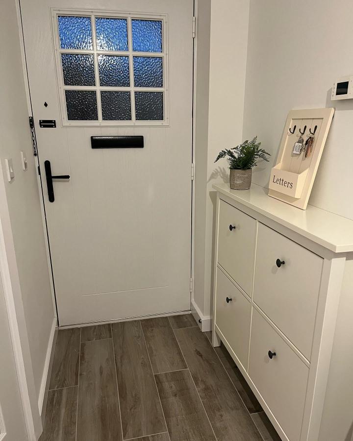 White HEMNES shoe cabinet in small hallway from @our_tudor_hallam with black knobs and simple decor creating efficient entry storage.
