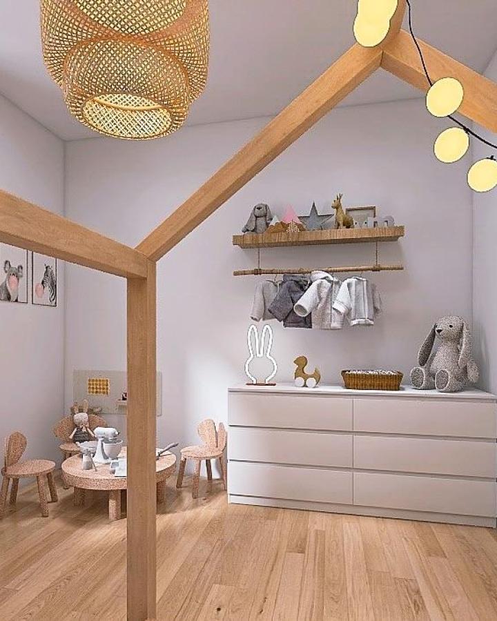White minimalist dresser and natural wood nursery elements from @lauri.pieretti with playful soft toys and cozy lighting in a child's room.