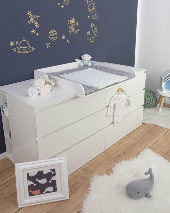 White minimalist Ikea Malm dresser nursery setup from @puckdaddy.de with changing pad and space-themed wall decals ikea malm nursery ideas.