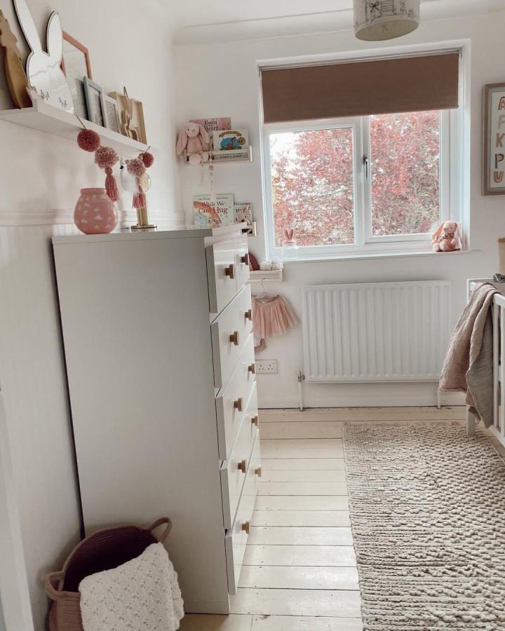 Soft beige Ikea Malm dresser in serene nursery setup from @elocin_home with neutral accents and subtle pink touches reflecting ikea malm nursery ideas.