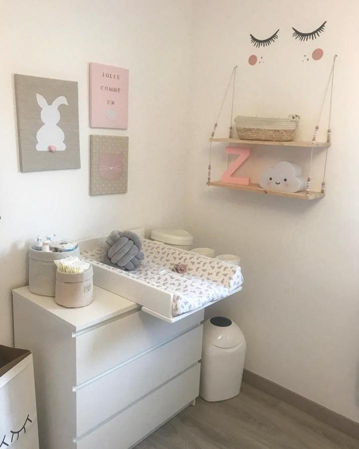 Soft pastel nursery with Ikea Malm dresser and hanging bead shelves from @lifestyle_july stylish baby room setup.