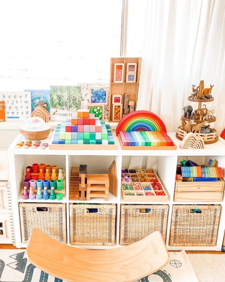 Natural woven IKEA BRANÄS baskets and colorful wooden toys in a bright Montessori playroom setup from @where_learning_meets_play showcasing ikea montessori playroom ideas.