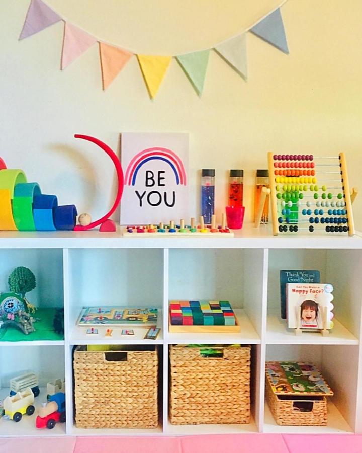Colorful white Kallax shelving with LABBSAL baskets and UNDERHÅLLA abacus by @geraldine.official in ikea montessori playroom ideas, bright and organized.