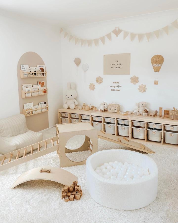 Natural wood and neutral toned playroom storage and soft play equipment from @thesweetapplelife with minimalist child-friendly design and cozy textures.