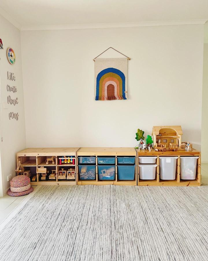 Natural wood Ikea TROFAST storage unit in kids playroom from @woodenplayjourney showcasing ikea montessori playroom ideas with organized bins and toys.