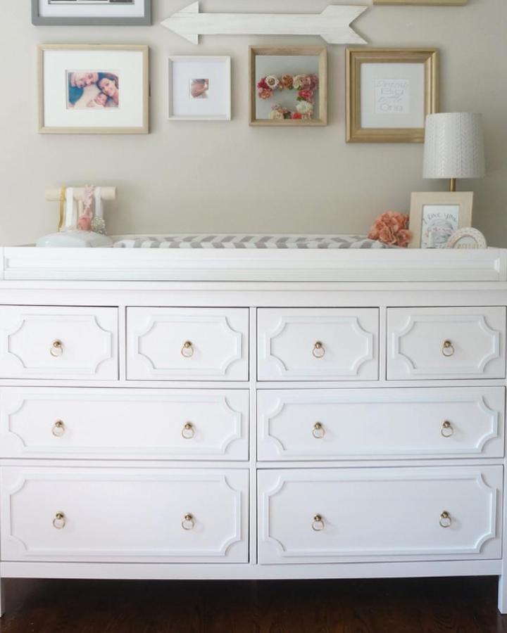 White classic Hemnes dresser with brass hardware from @cindy_made2style styled as Pottery Barn inspired nursery changing table with molding details.
