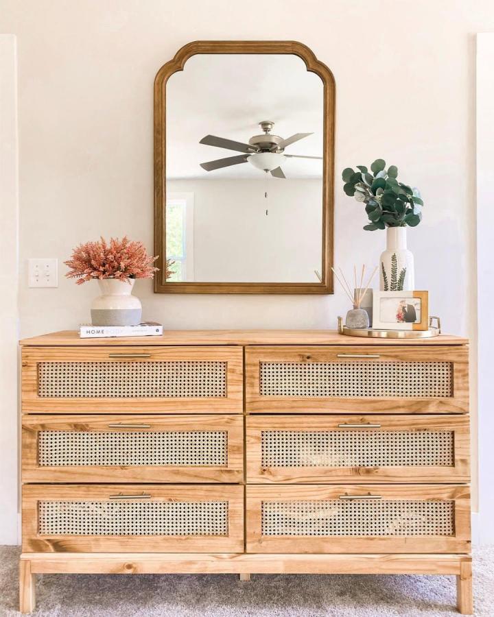Natural pine dresser with woven rattan drawer panels and brass handles by @julianna_claire styled for cozy rustic vibes.