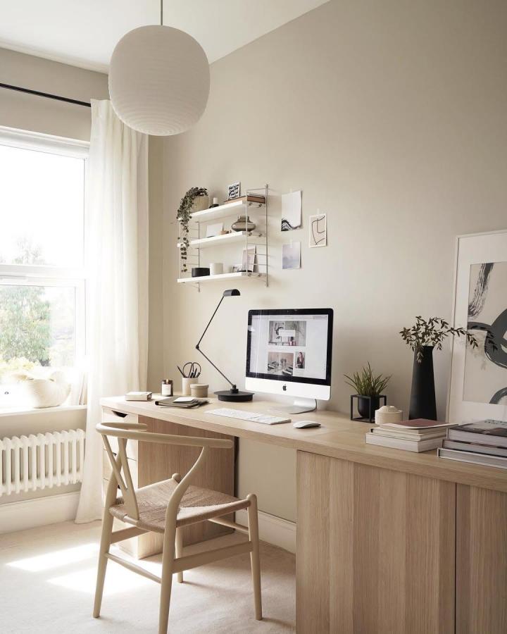 Light wood minimalist desk setup with shelves and decor from @thesefourwallsblog featuring stylish affordable home office furniture hacks.